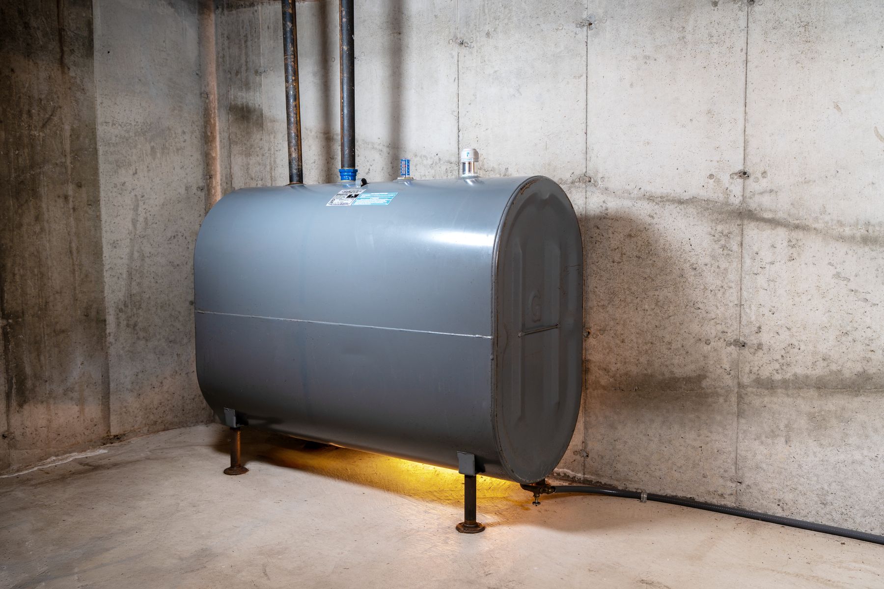 A heating oil tank in a basement with a Smart Oil Gauge installed on top
